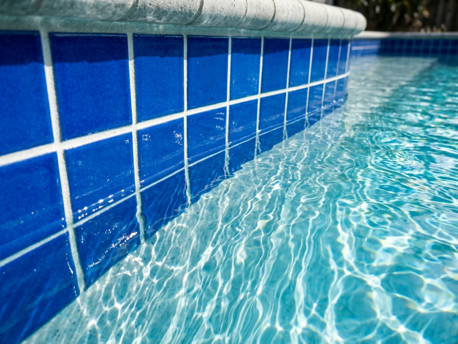 Glossy clean blue waterline tile and clear water after Allure Pools acid and calcium wash, Henderson NV